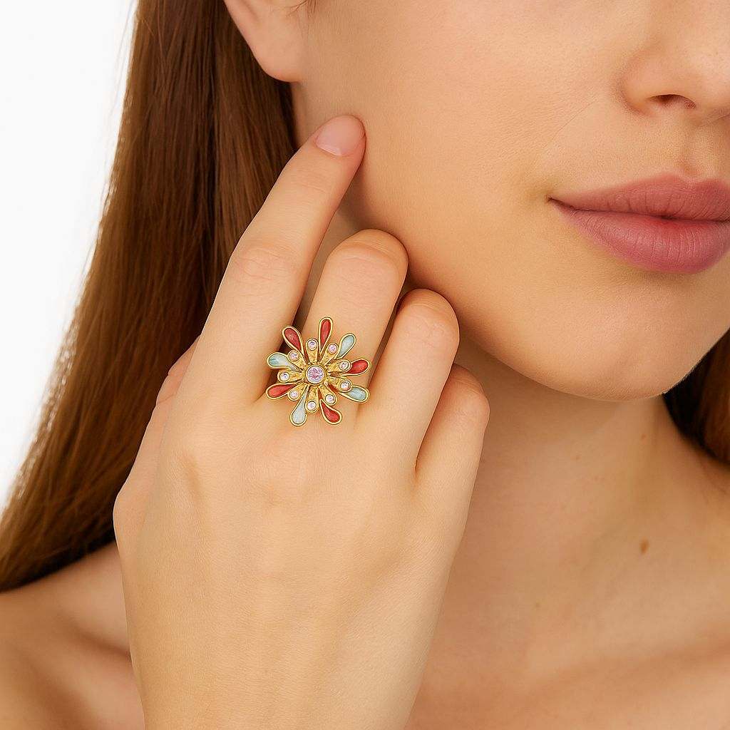Gold adjustable flower enamel ring with colorful petals and crystal center worn on woman's finger