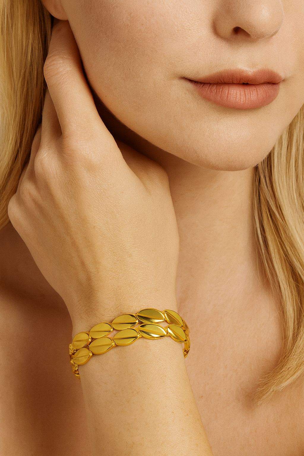 Leaf-inspired oval KC gold plated bracelet on wrist, minimalist modern style from Pallas Jewellery
