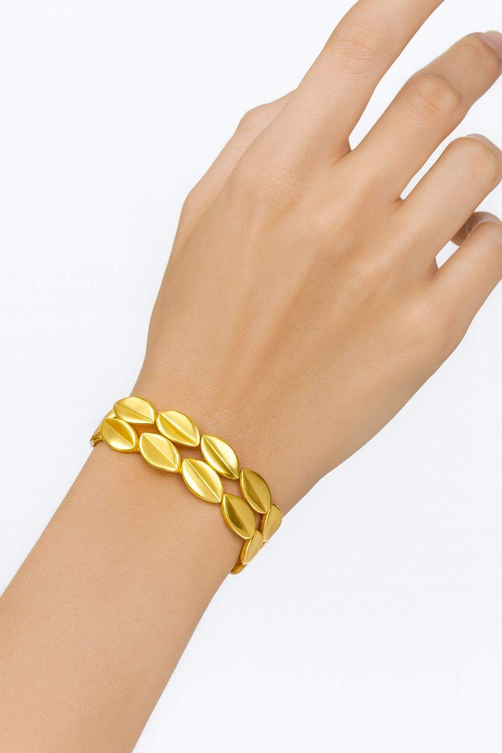 Leaf-inspired oval KC gold plated bracelet with sleek minimalist design on wrist