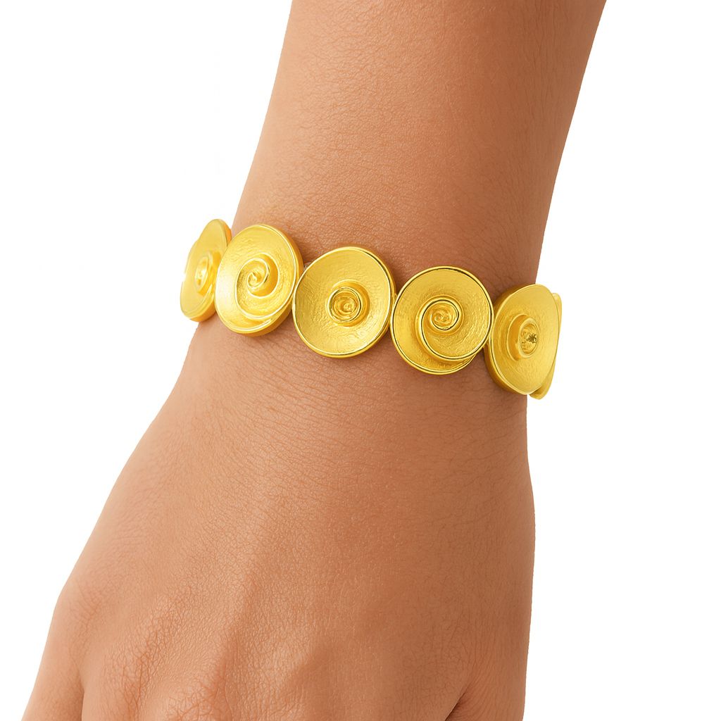 Spiral Swirl KC gold plated bracelet with textured circular discs on wrist