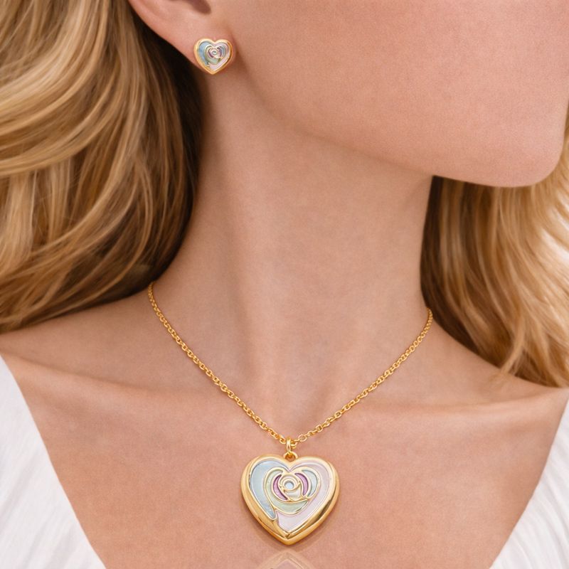 Close up of pastel enamel heart earrings with gold plating