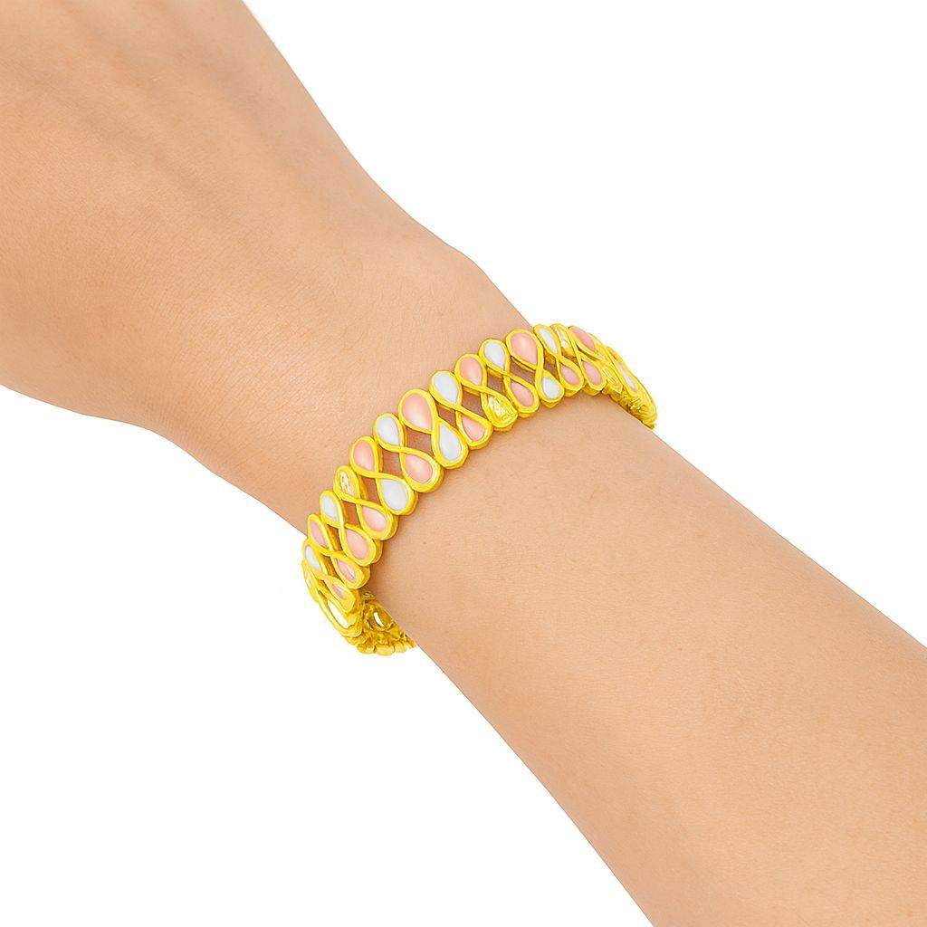 Close-up of hand-painted enamel bracelet in gold