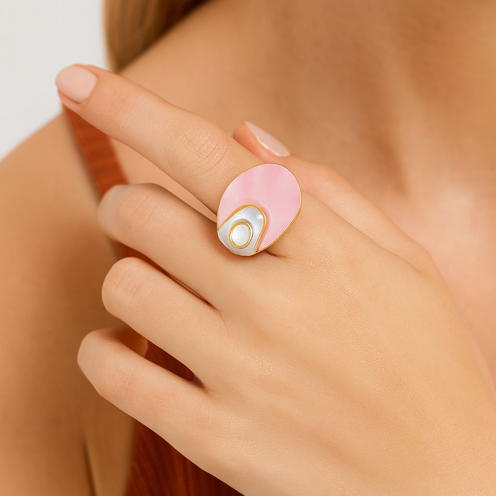 Asymmetrical pink enamel ring worn on hand