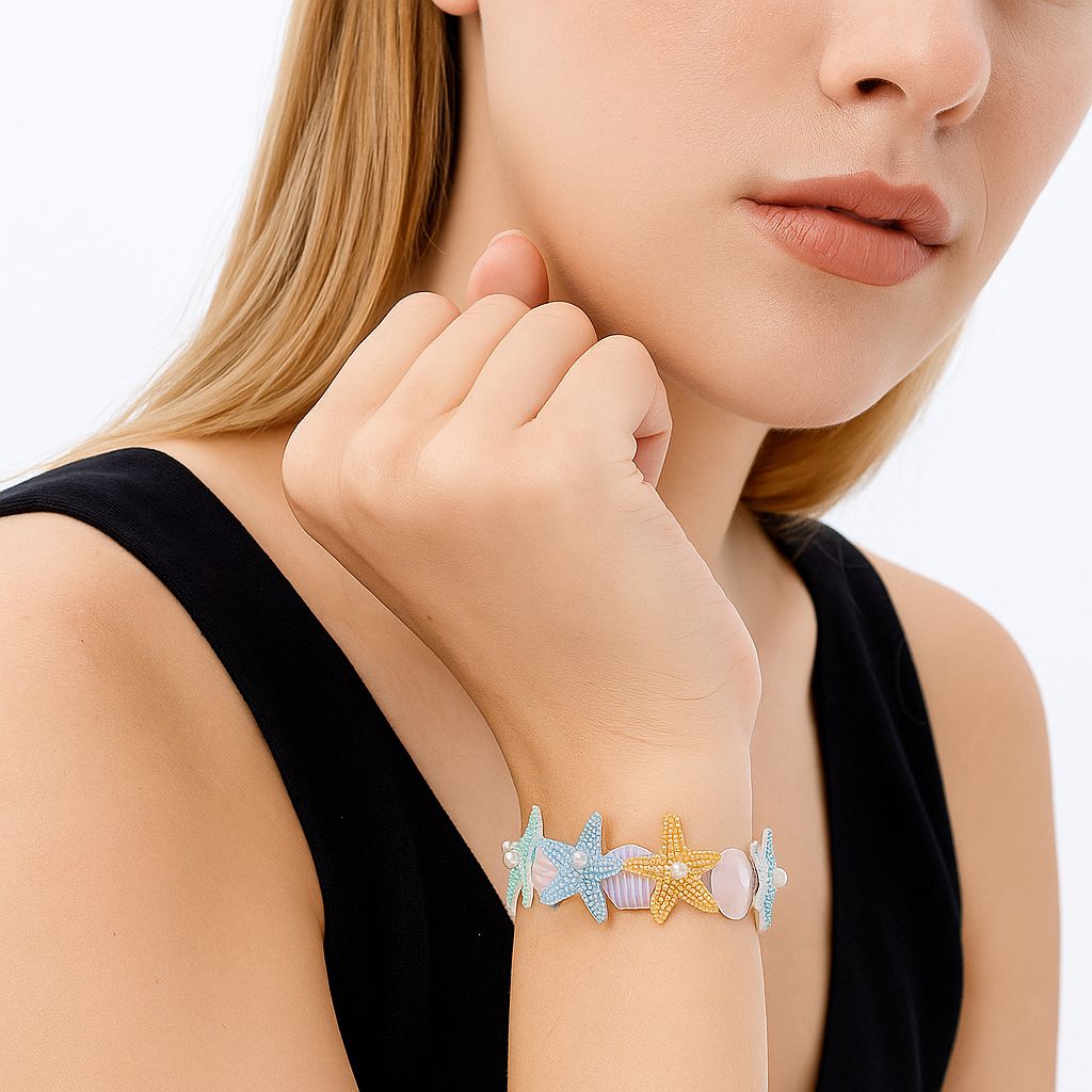 Detailed view of pastel starfish and seashell enamel bangle