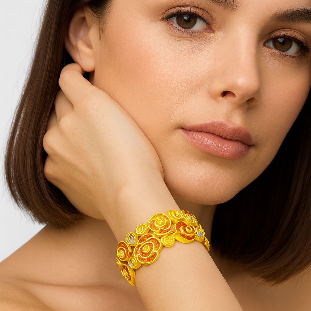Hand-painted rose swirl bracelet worn on wrist with gold, coral, and silver tones