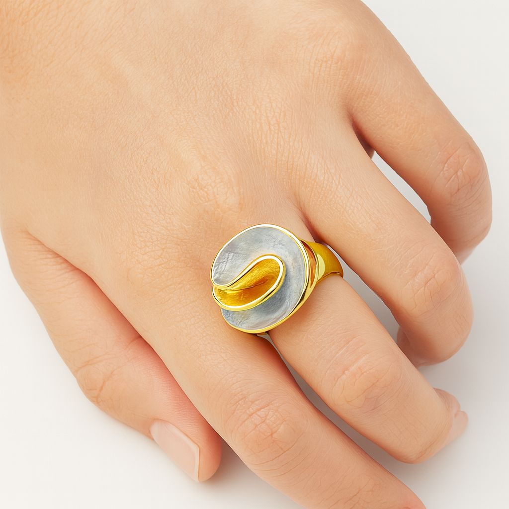 Model wearing KC gold spiral bloom ring with grey-blue and coral hand-painted enamel