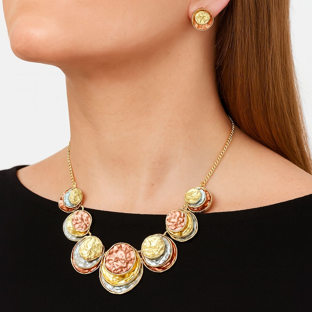 Model wearing gold and copper hammered circle statement necklace