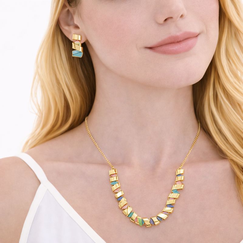 Close up of hand painted enamel geometric jewelry with KC gold plating