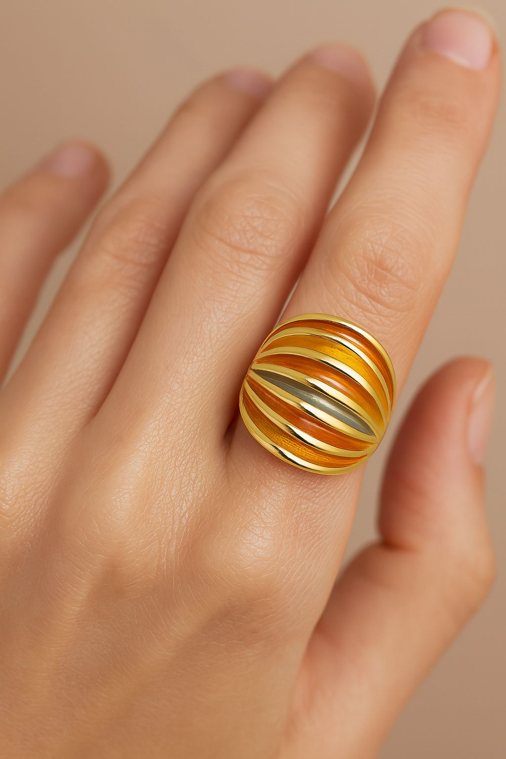 Close-up of striped enamel dome ring in KC gold on finger