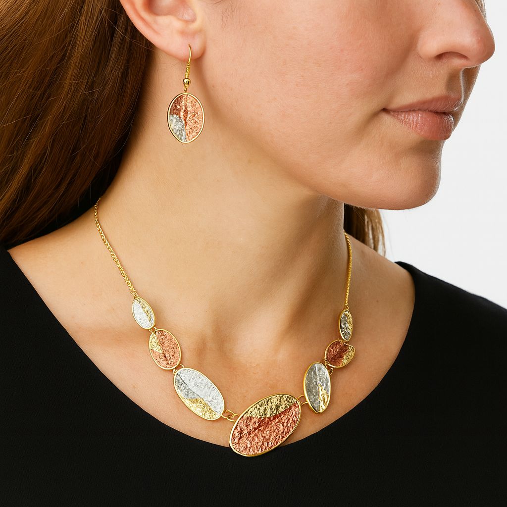 Close up of hand-painted oval pendant with textured finish