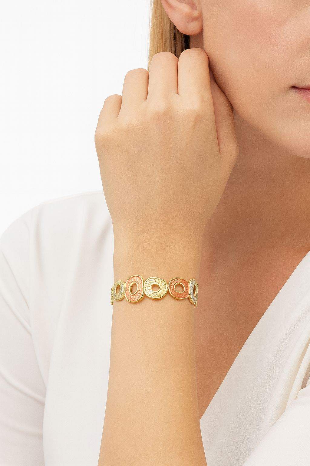 KC gold plated multi-tone oval open circle textured bracelet on woman's wrist