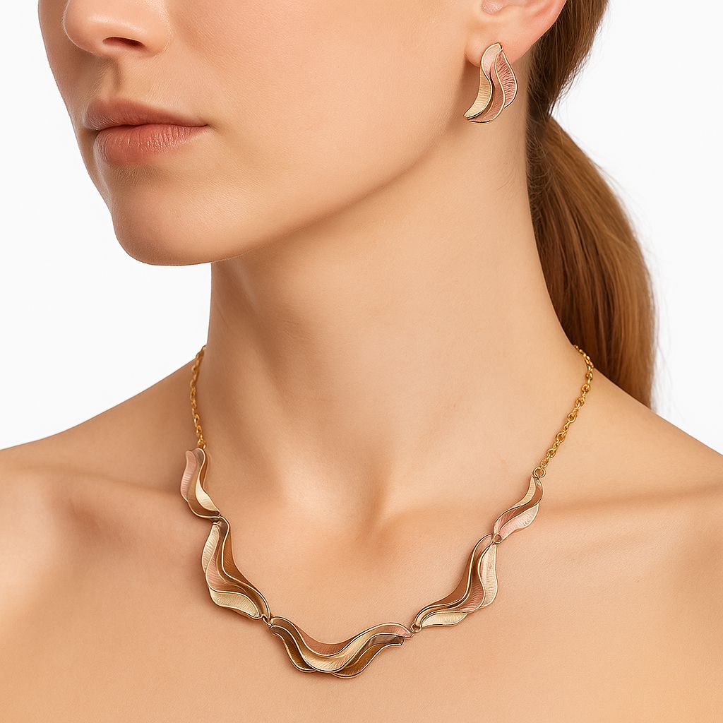 Gold plated layered wave earrings close up view