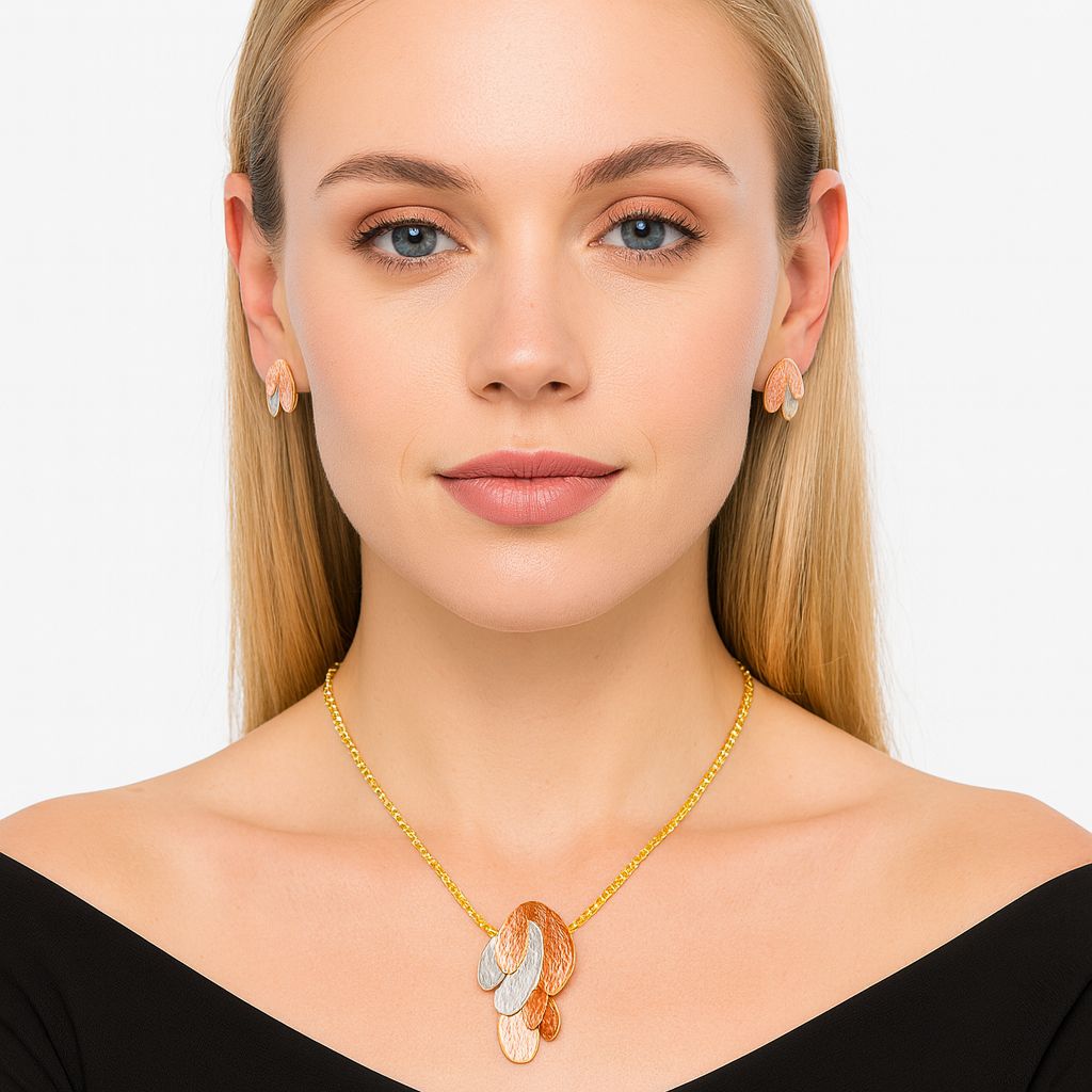 Model wearing layered oval textured necklace and matching stud earrings