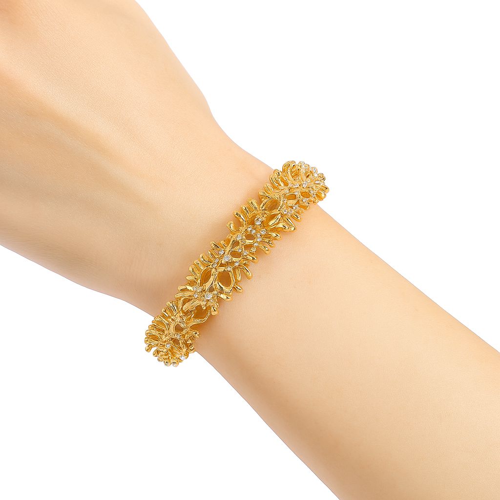 “Model wearing handcrafted KC gold enamel bracelet”