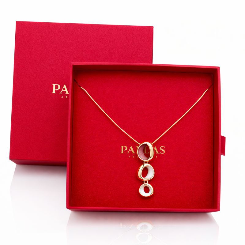 Gold enamel necklace and earrings set displayed in gift box