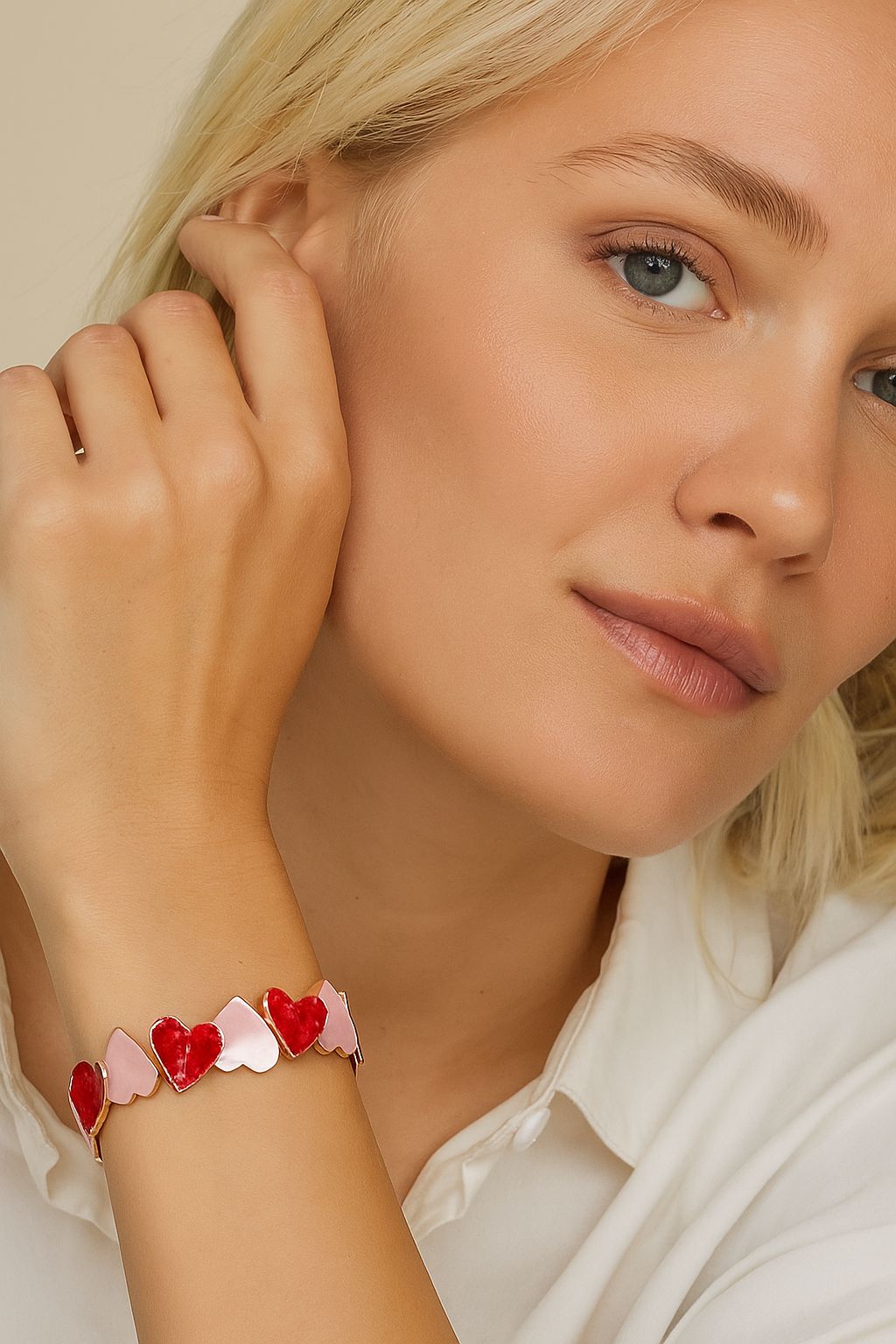 Fashion model styling KC gold hand-painted heart bracelet with red and pink enamel