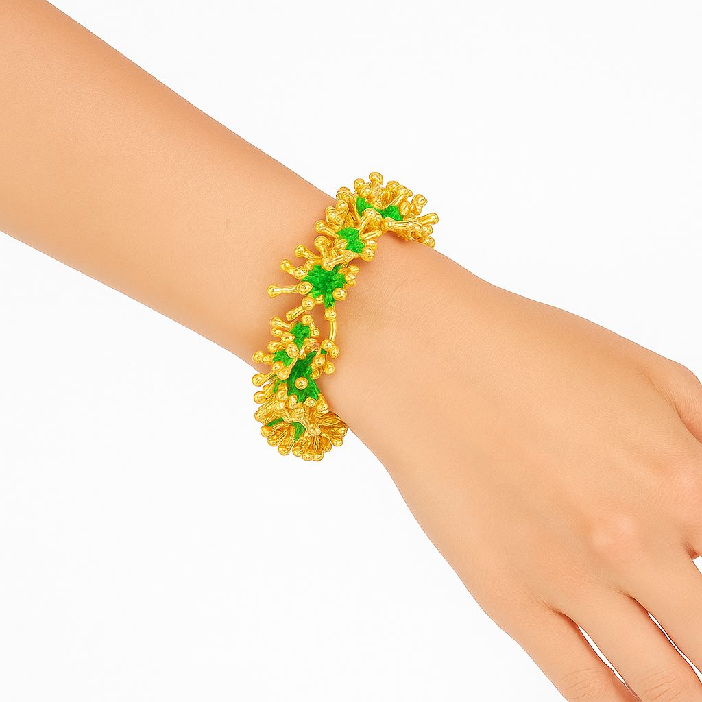Model wearing green enamel leaf bracelet