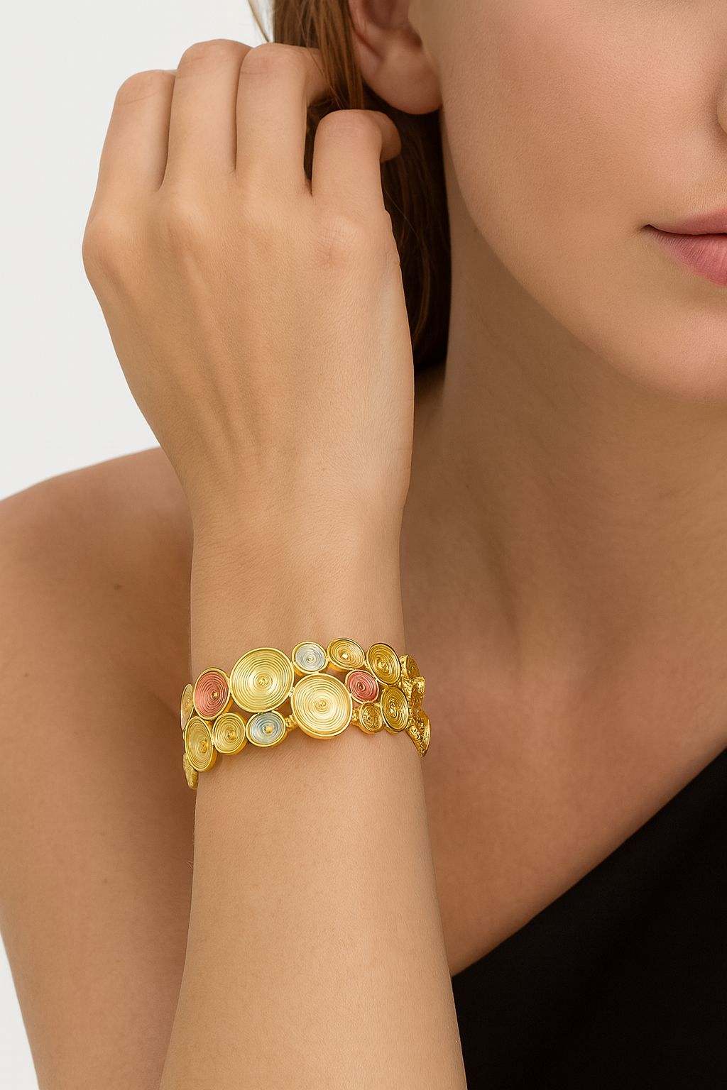 Close-up view of spiral pattern gold bangle