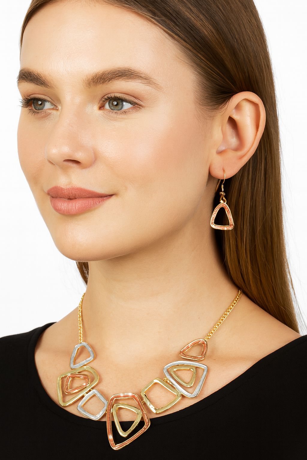 Model wearing modern geometric triangle necklace in gold tones