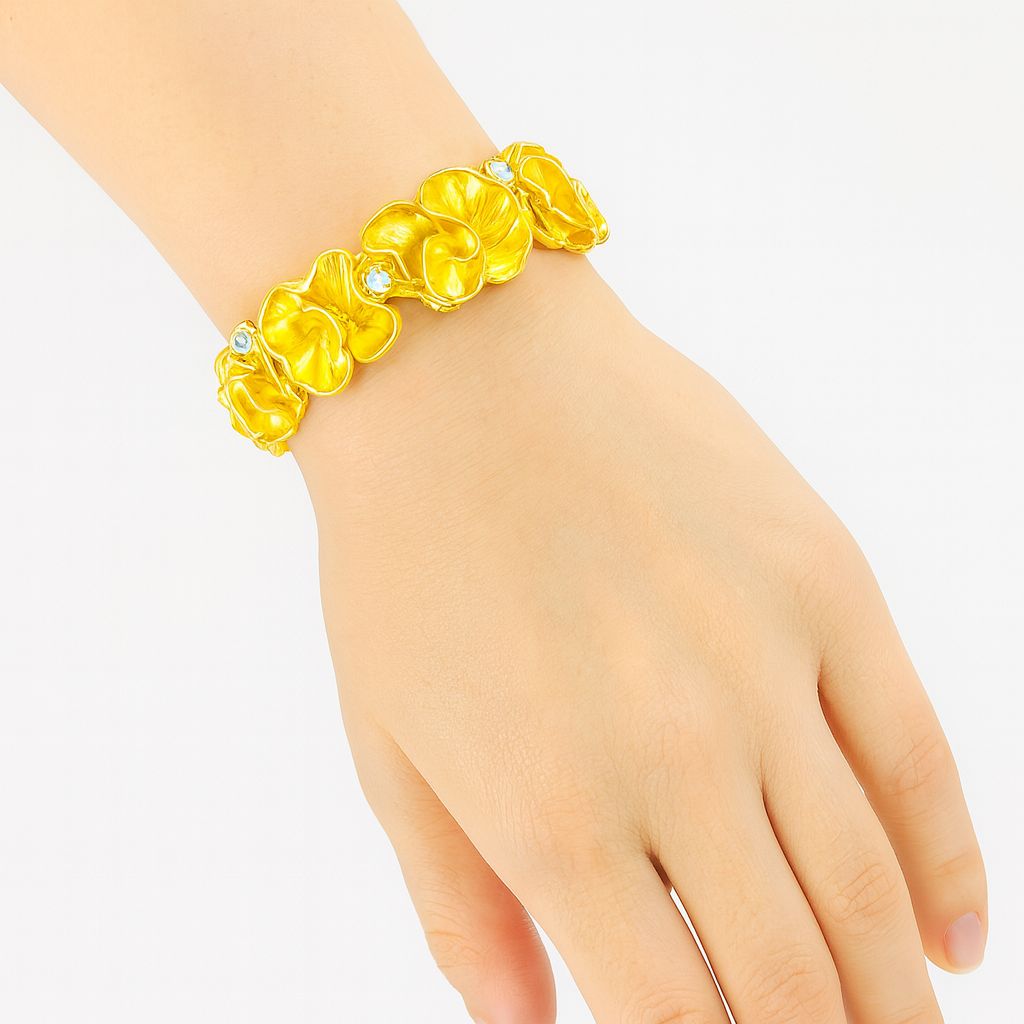 Model wearing gold floral bangle on wrist