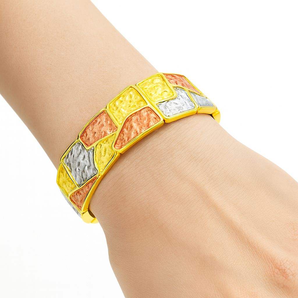 Woman wearing mosaic hand-painted gold bangle on wrist