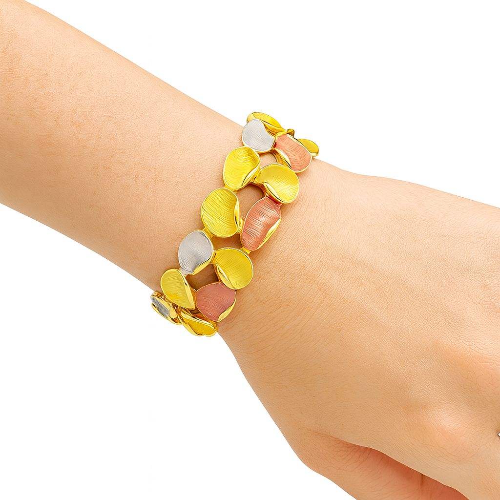 Woman wearing tri-color enamel gold bangle bracelet